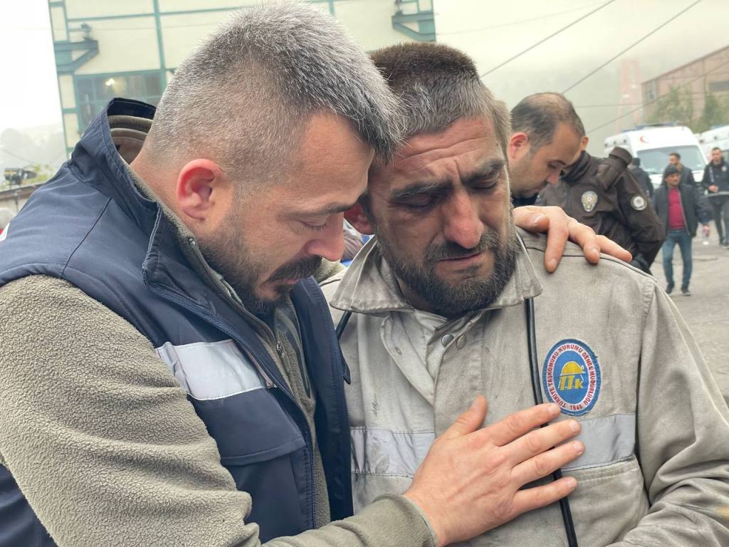 A co-worker of the coal miners, trapped underground, is consoled as search and rescue operation continues after an explosion occurred at a coal mine in Turkiye's northern Bartin province on October 15, 2022.