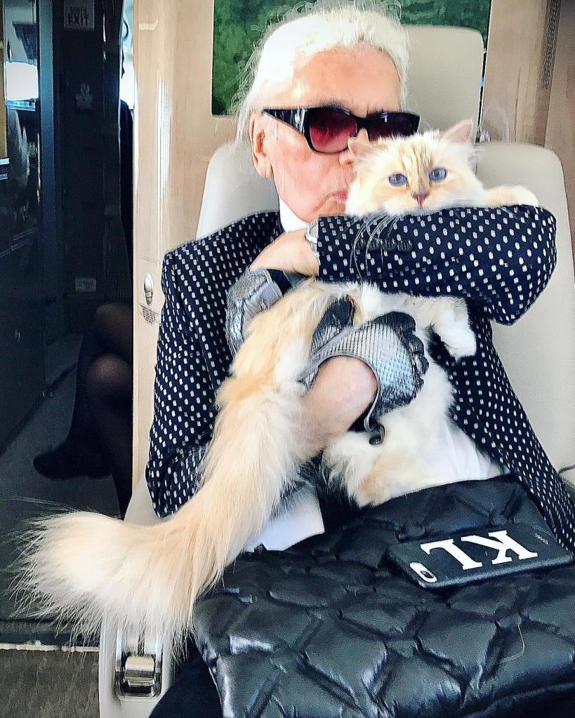 Karl Lagerfeld holding his cat Choupette