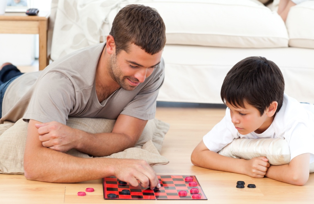 Father and son playing checkers.